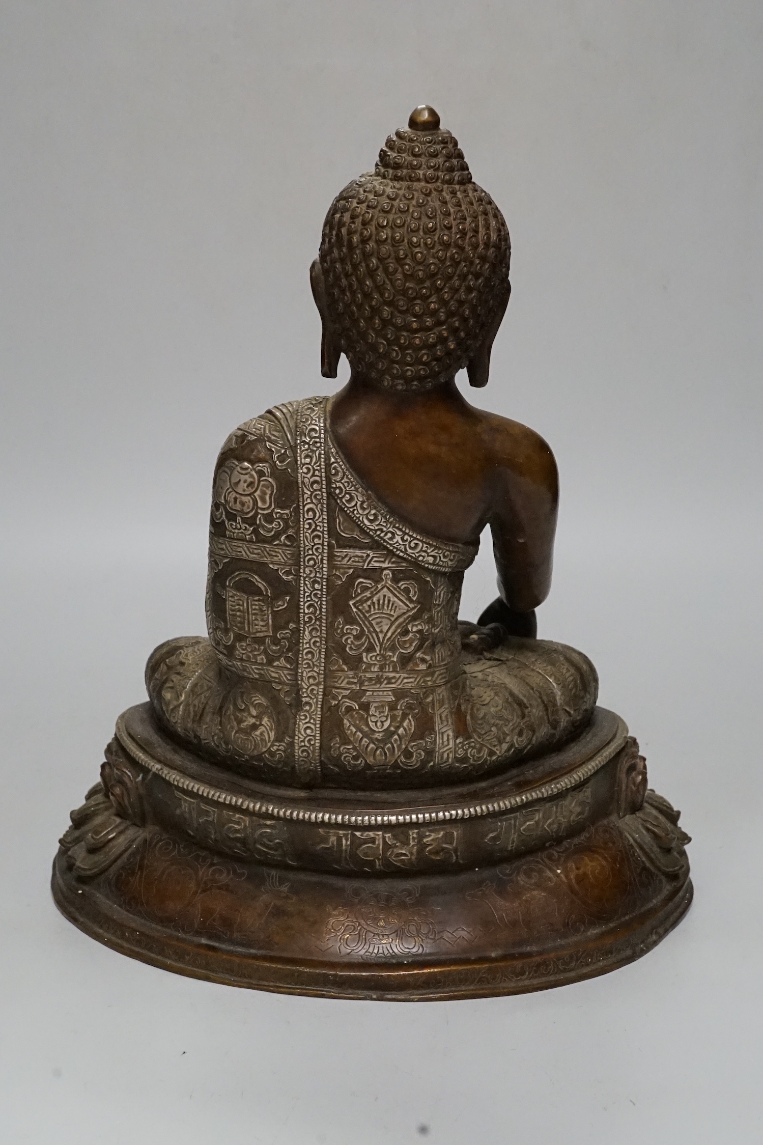 A silver overlaid bronze figure of Buddha Shakyamuni, 26cm